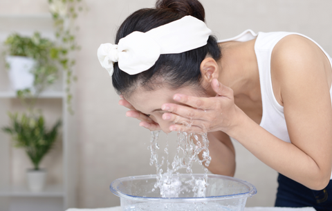 Woman washing her face